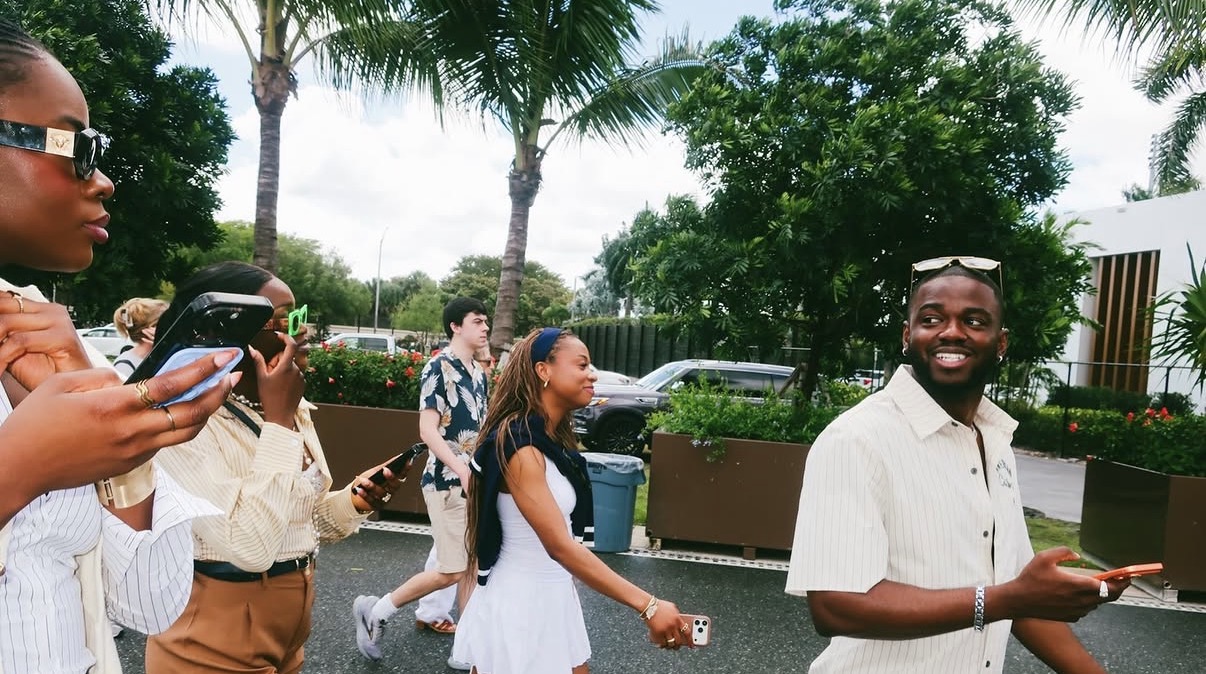 Guests walking together between activities under palm trees during a group trip